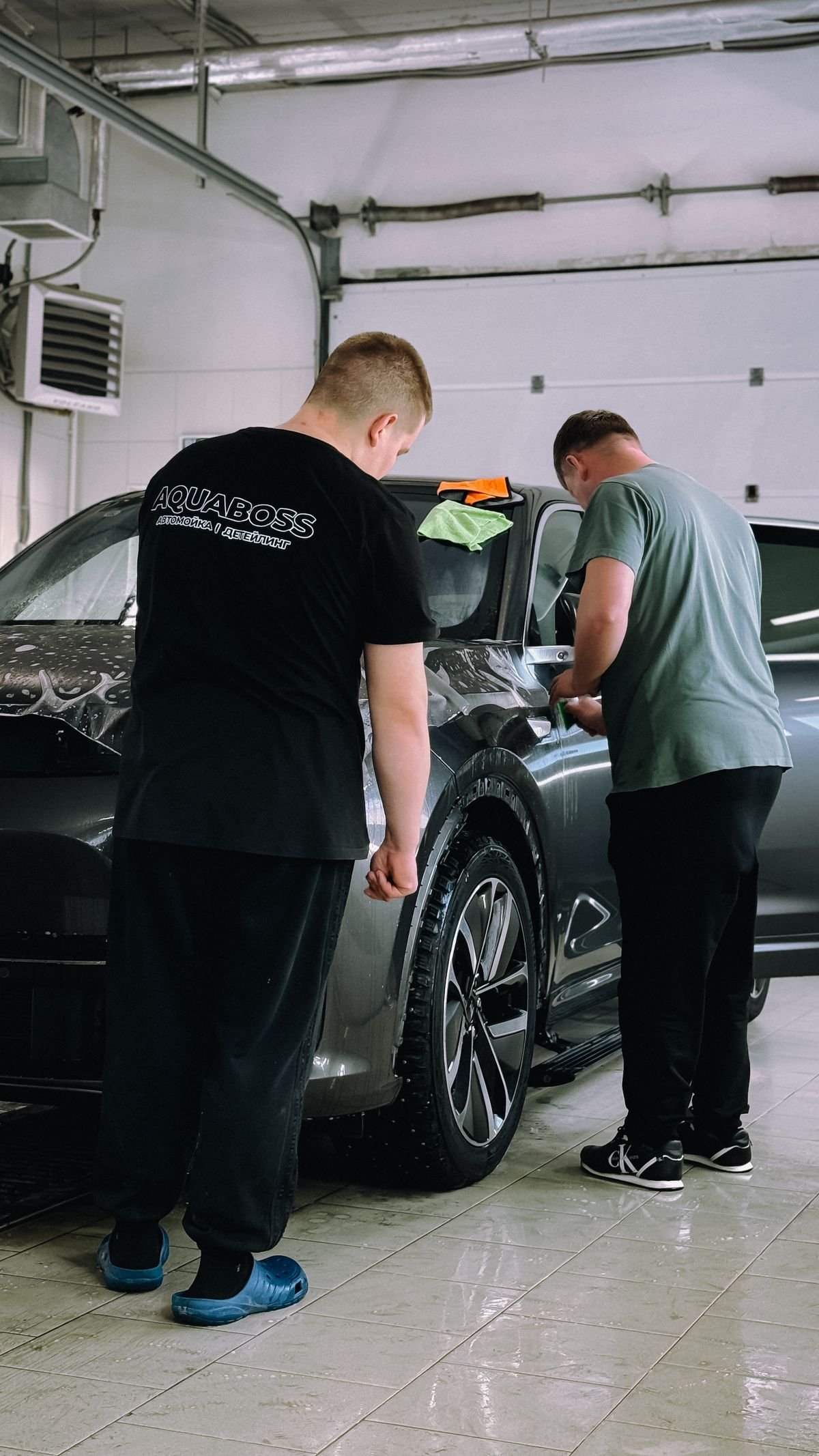 Detailing professionals working on a car